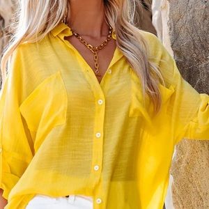 Vibrant yellow blouse with roll tab sleeves. Gently worn.